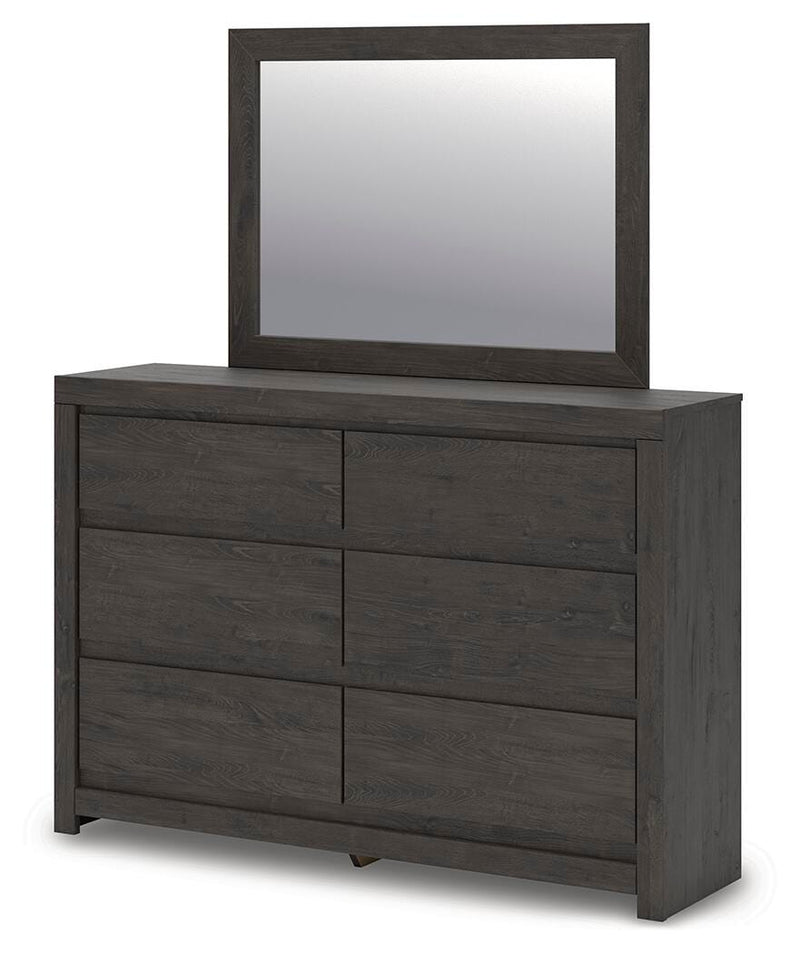 Ashley Furniture Fraluna bedroom set includes a bed with a padded headboard and matching nightstands in a stylish bedroom scene.