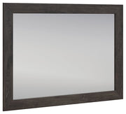 Ashley Furniture Fraluna bedroom mirror with a sleek, modern design, angled view showing its stylish frame and reflective surface.