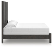Ashley Furniture Fraluna bedroom set with a bed, nightstands, and dresser in a modern design, shown from a side angle.