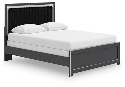 Ashley Furniture Zuraleus Bed with a modern frame and neutral upholstery, shown from a side angle in the image.