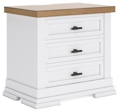 Ashley Furniture Ashbryn nightstand with a warm wood finish and modern design, shown from an angled side view.