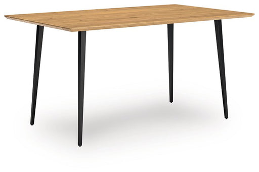 Ashley Furniture Gretlynn dining table with a wood finish, shown from an angled side view in a modern dining room setting.