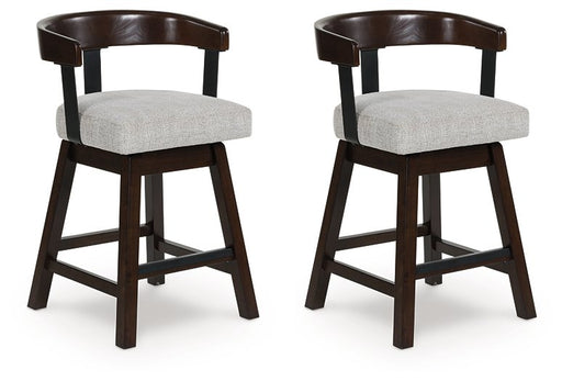 Two Ashley Furniture Haddigan counter height barstools with dark wood finish and padded seats, shown from an angled side view.