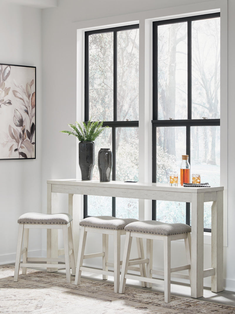 Ashley Furniture Robbinsdale counter height dining table with three matching barstools, featuring a modern wood finish and sturdy design.