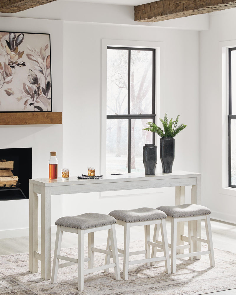 Ashley Furniture Robbinsdale counter height dining table with three matching barstools, featuring a modern wood finish and sturdy design.