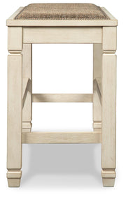 Ashley Furniture Bolanburg dining room set with a wooden table and matching chairs, shown from a side view.