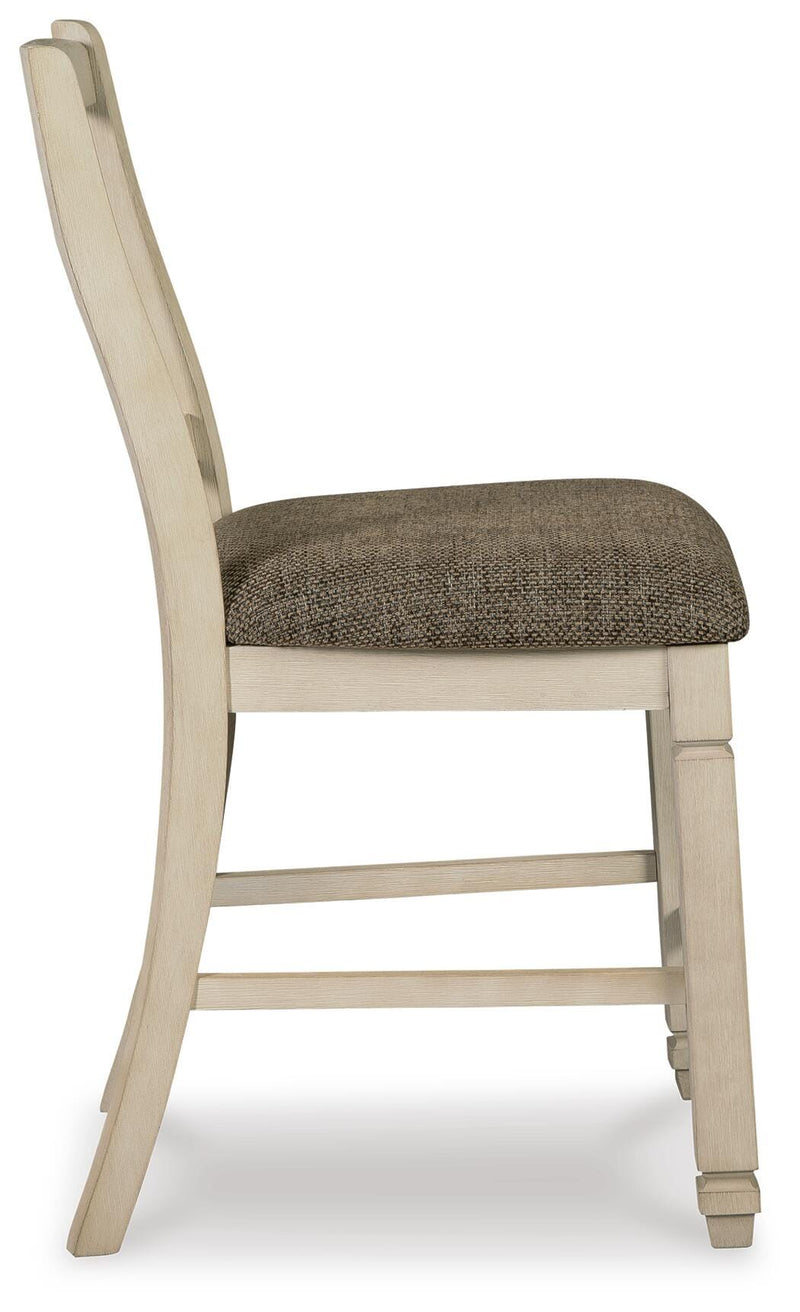 Ashley Furniture Bolanburg dining room set with a wooden table and matching chairs, shown from a side angle.