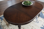 Ashley Furniture Lavinton dining extension table with leaf, showcasing the wooden surface and extended table setup.
