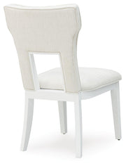 Ashley Furniture Chalanna dining chair with dark wooden legs and upholstered seat and back, shown from the back view.
