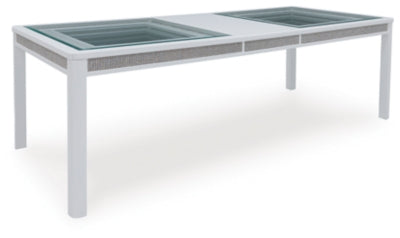Ashley Furniture Chalanna dining extension table with leaf, shown from an angle, showcasing its wood finish and elegant design.