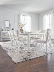 Ashley Furniture Chalanna dining room set with a table and matching chairs, featuring a modern design in a well-lit dining space.