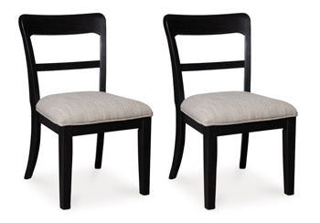 Ashley Furniture Greddinton dining room set with a wooden table and six matching upholstered chairs, shown from a side angle.