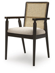 Ashley Furniture Galliden dining arm chair with upholstered seat and wooden legs, shown from an angled side view.