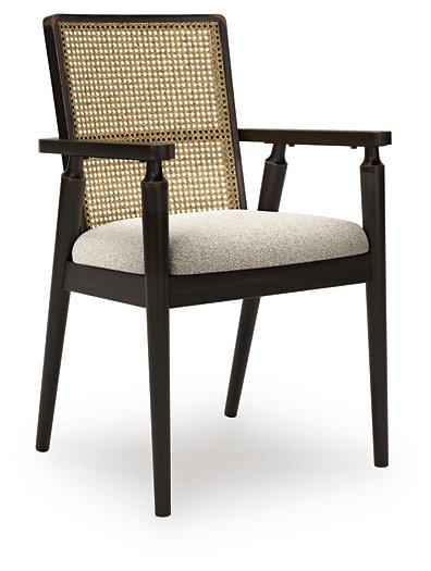 Ashley Furniture Galliden dining arm chair with wooden frame and upholstered seat, shown from an angled side view.