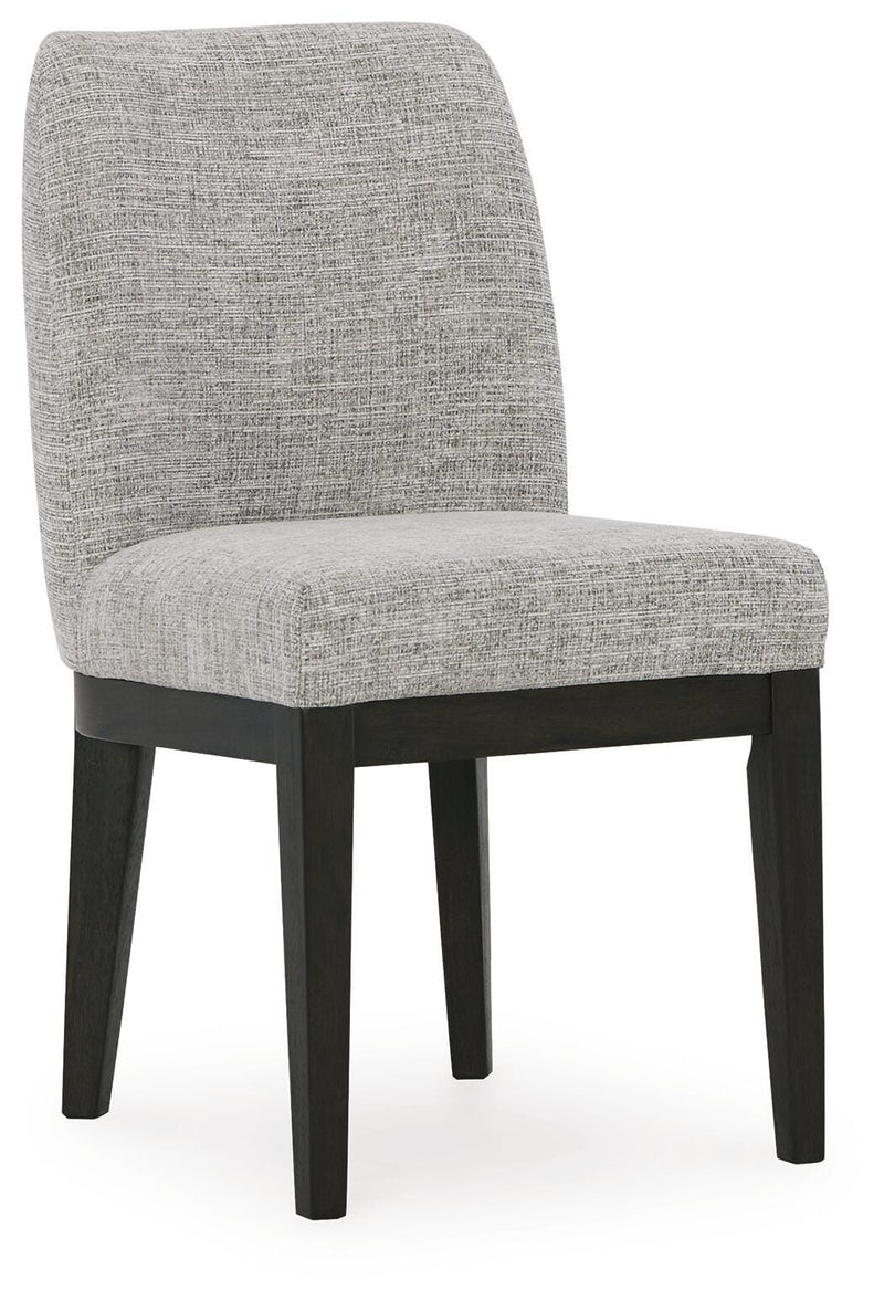 Ashley Furniture Burkhaus dining room set with a table and chairs, angled view showing wood finish and modern design.