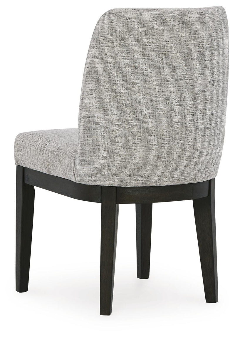 Ashley Furniture Burkhaus dining room set with a wooden table and six matching chairs, shown from the back in this image.