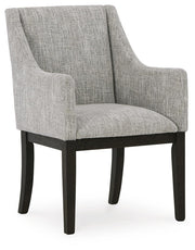Ashley Furniture Burkhaus dining room set with a table and six upholstered chairs, shown from an angled view.