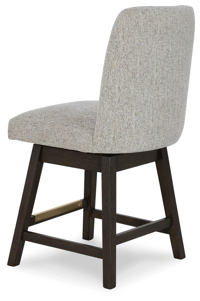 Ashley Furniture Burkhaus dining room set with a wooden table and upholstered chairs, viewed from an angle showing the back and side.