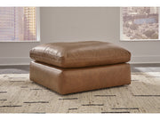 Emilia leather sectional by Ashley Furniture with a matching ottoman, showcasing plush cushions and modern design.