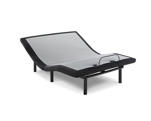 Ashley Furniture California King adjustable base with head and foot remote control, shown from an angled side view.