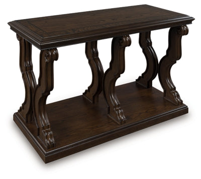 Ashley Furniture Maylee sofa table with a sleek wooden surface and metal legs, shown from an angled side view.