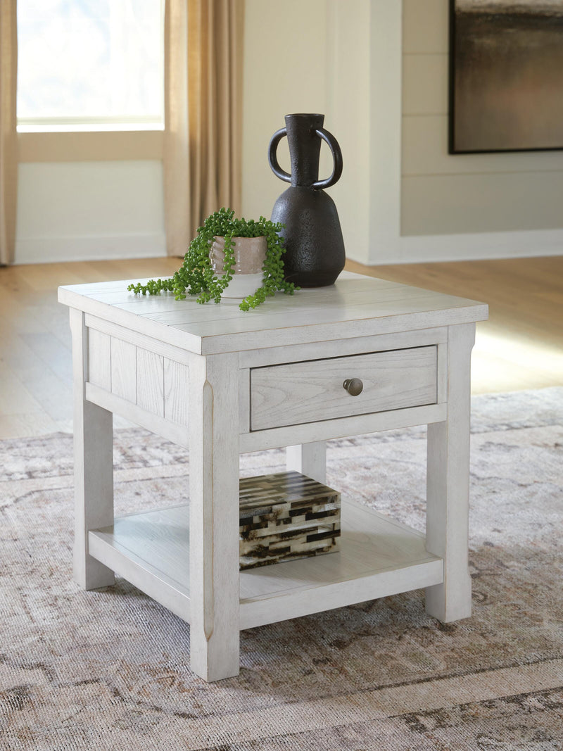 Ashley Furniture Robbinsdale End Table with a rectangular top and sturdy wooden legs, shown in a close-up crop image.