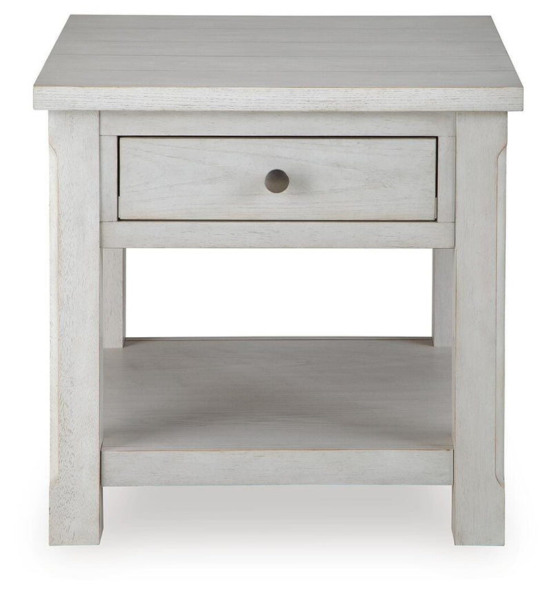 Ashley Furniture Robbinsdale End Table with a sleek wood finish and modern design, shown from a head-on angle.