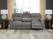 Ashley Furniture 5Z-Comfort Power Reclining Sofa showing plush fabric upholstery and reclining mechanism in a modern living room setting.