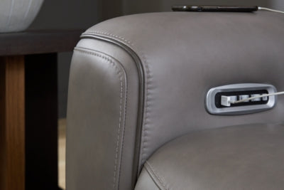 Ashley Furniture 5Z-Comfort Power Reclining Sofa with stitched welt detail, showcasing plush upholstery and reclining features.
