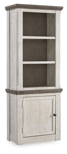 Ashley Furniture Havalance left pier cabinet, closed view showing wood finish and decorative details on the pier cabinet.
