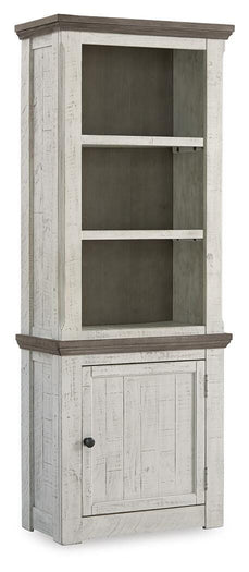 Ashley Furniture Havalance right pier cabinet with closed doors, showcasing a stylish wood finish and modern design.