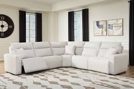 Ashley Furniture Modmax II power reclining sectional with plush fabric and built-in audio console, shown in a modern living room setting.