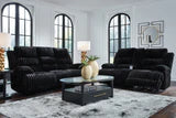 Ashley Rhine Falls living room set with power reclining sofa and loveseat featuring a drop-down table and plush upholstery.